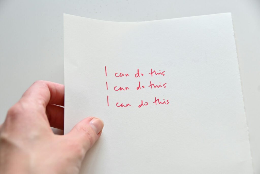 A piece of paper with “I can do this” written on it three times