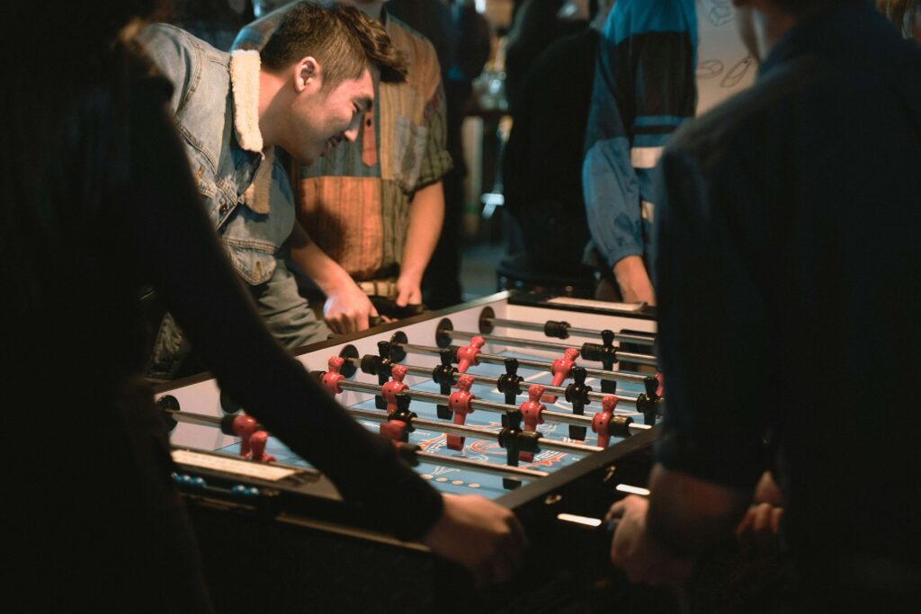 A group of friends using a football table